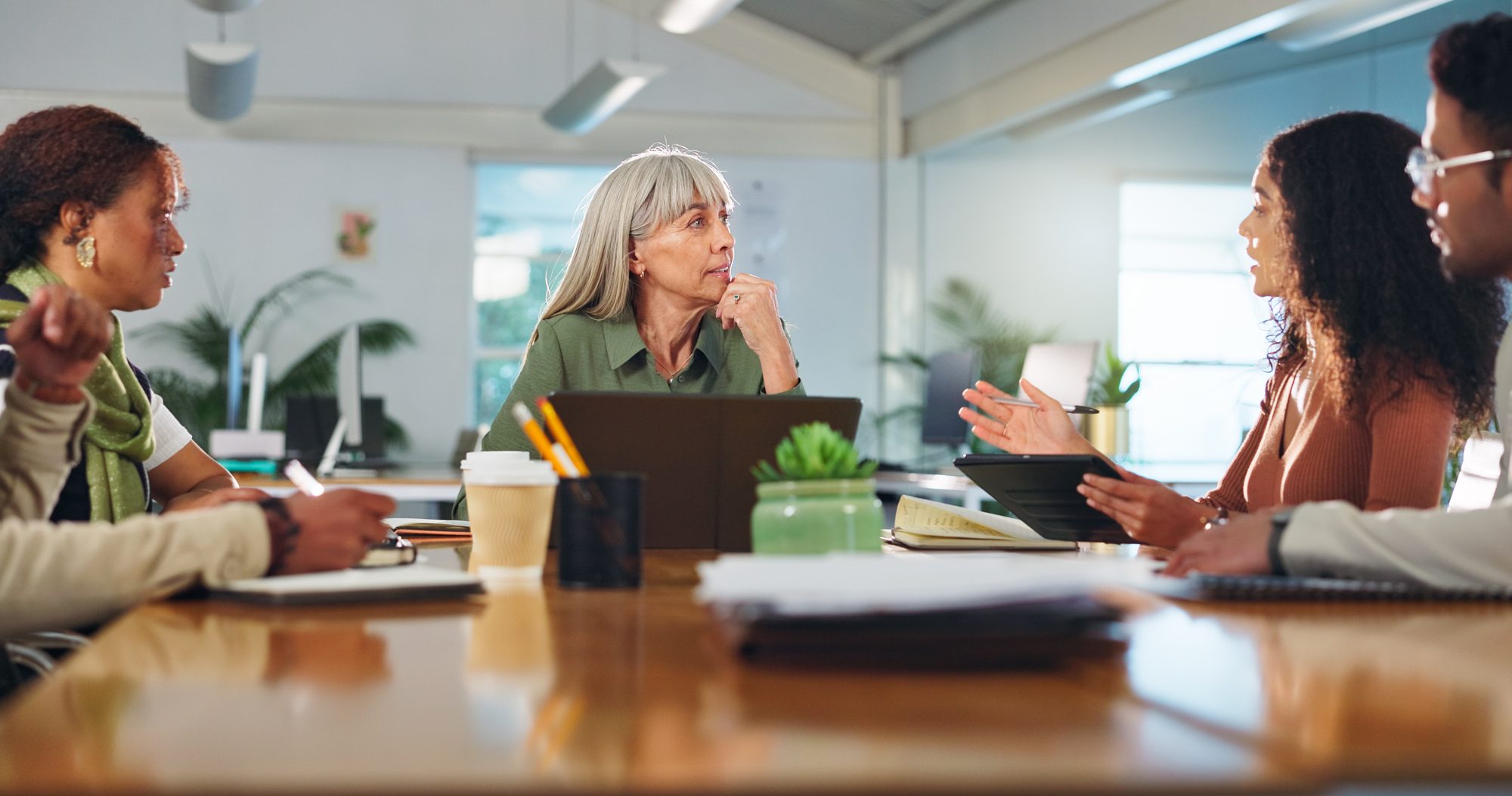 A team meeting around a table discussing business plans